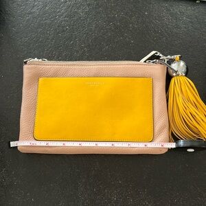 Tan yellow and white crossbody back by Tory Burch with large removable tassel